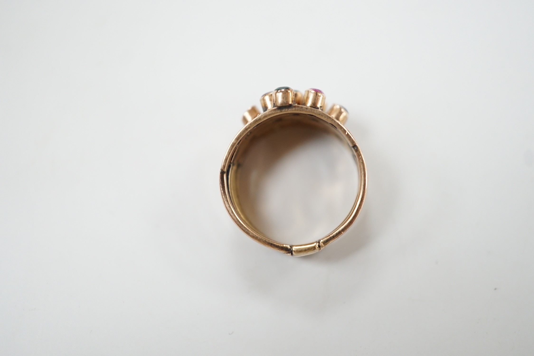 A yellow metal, quintuple band and multi gem set ring (stone missing), size H, gross weight 4.5 grams.